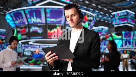 Diverse Group Of Fintech Workers Analyzing Global Stock Market Trends Stock Photo