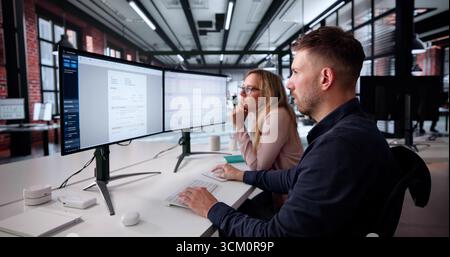 Businesswoman And Analyst Overseeing Spreadsheet On Desktop Computer In Office. Stock Photo