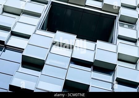 A detailed close-up of a modern building facade with a geometric pattern. The abstract composition and architectural details are highlighted Stock Photo