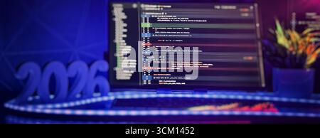 Glowing 2026 numbers in front of a digital screen filled with code, symbolizing future programming and technological innovation. Stock Photo