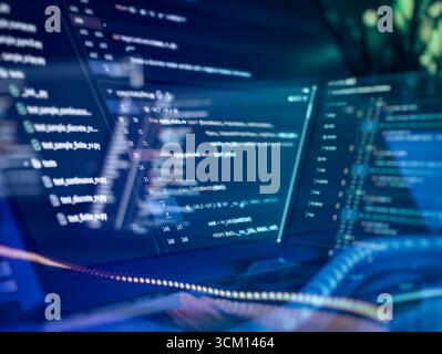 Modern software development with multi-screen coding setup Stock Photo