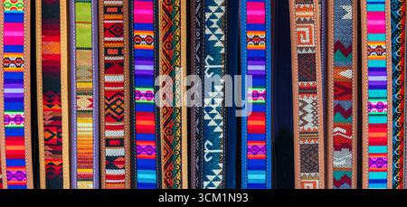 Panorama of native indigenous style belts, Otavalo handicraft market, Ecuador, South America. Stock Photo