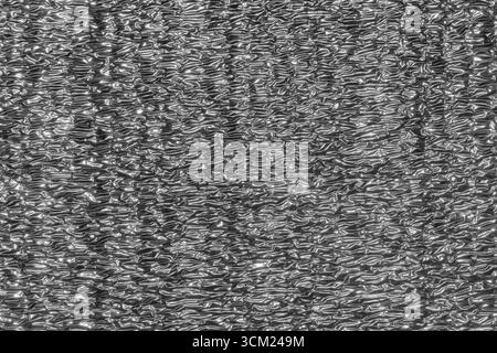 Abstract gray wavy background. Close-up of a sheet of penofol, insulation with a foil surface Stock Photo