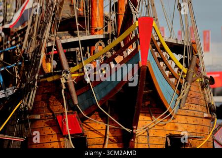 Close view of a colourful wooden bow with ropes and fittings on a historic vessel, documented at Sail 2025 in Amsterdam, Netherlands, warm evening. Stock Photo