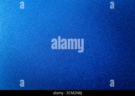 Blue abstract surface with grainy texture and matte background with central focus, close up Stock Photo