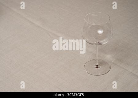 Empty Burgundy Red Wine Glass on a Table Stock Photo