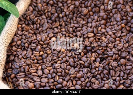 A Burlap Sack Filled with Local African Coffee Beans Displayed in a Close-Up Rustic Composition Stock Photo