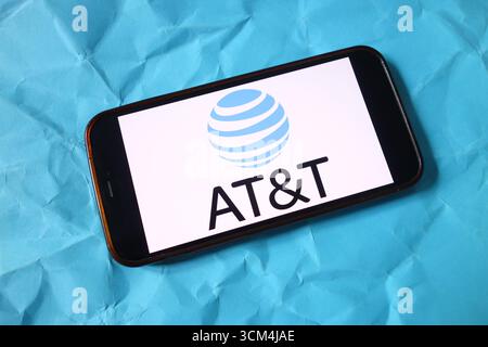 In this photo illustration an AT&T logo seen displayed on smart phone ...