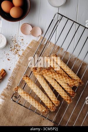 Traditional homemade waffle rolls with ingredients on rustic kitchen background Stock Photo