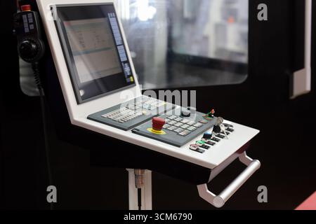 Control console of manufacturing CNC machine close up. Selective focus. Stock Photo