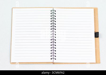 close up to a blanked notebook with a white lined sheets over a white background Stock Photo