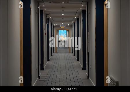 Long corridor with many doors in modern hotel Stock Photo