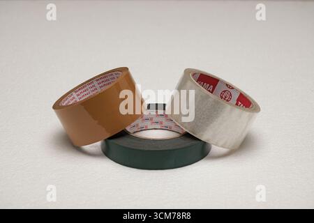Three rolls of adhesive tape in various colors on a white background Stock Photo