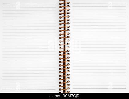 Open spiral notebook featuring blank lined pages, inviting notes, ideas, and stories, embodying endless potential for creativity and organization Stock Photo