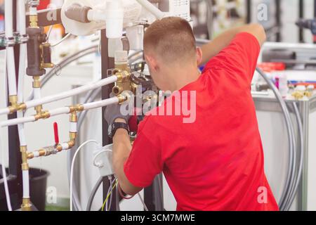 Installing collector for warm water underfloor heating system. Plumber work. Stock Photo
