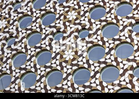 Geometric Islamic Lattice Facade with Circular Openings and Star Arabesque Pattern Detail Stock Photo