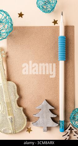 Colorful Christmas flat lay featuring blank paper, decorative items, and a pencil, perfect for holiday-themed creative projects and designs, stories t Stock Photo
