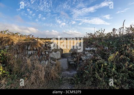 A stone wall with steps and farmland beyond, near Cape Cornwall Stock Photo
