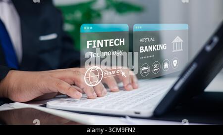 Businessman using laptop with fintech technology and virtual banking concept, digital finance innovation, online transactions, security, and future fi Stock Photo