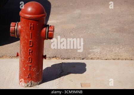 Red hydrant on concrete and asphalt floor Stock Photo