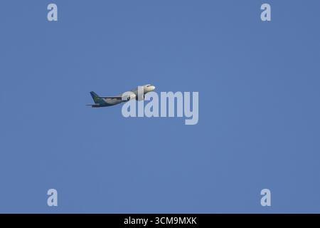 Airbus passenger jet aircraft of Aer Lingus flying in a blue sky, England, United Kingdom Stock Photo