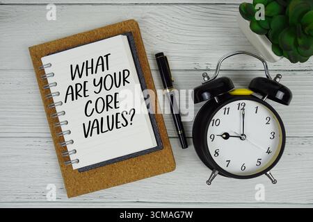 What Are Your Core Values? text written on notepad with alarm clock on wooden background Stock Photo