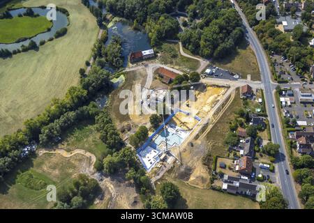 Aerial view of Mill Creek Lake surrounded by lush green forests under a ...