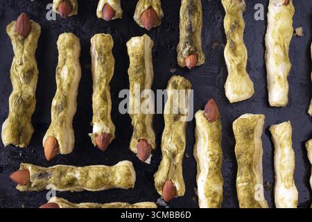 Halloween puff pastry and green toes matcha cookies flat lay Stock Photo