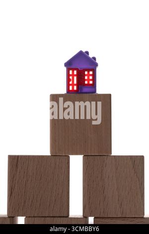 House on wooden blocks isolated on white background. Concept of property ladder Stock Photo