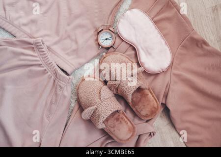 Flat lay composition with house slippers, sleeping mask and pajamas on light background Stock Photo