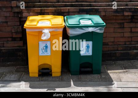 Yellow and green trash bin in the park, for organic and non-organic waste, Bali, Indonesia Stock Photo