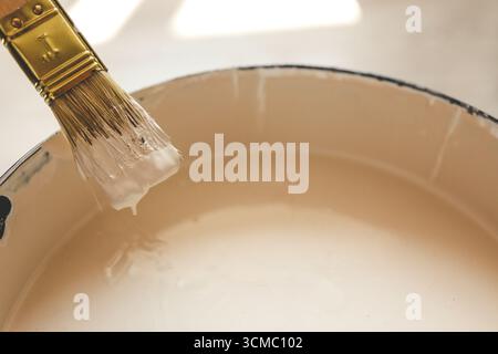 Paint brush resting on paint tin viewed from above. Stock Photo