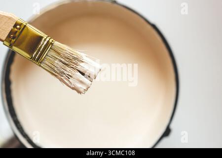 Paint brush resting on paint tin viewed from above. Stock Photo