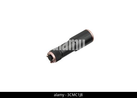 A compact black and copper-colored LED flashlight, isolated on a white background. Stock Photo