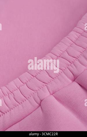 Warm pink tracksuit. Close-up of elastic waistband. Cotton. Macro photo. Stock Photo