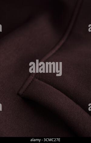 Close-up of dark brown fabric with a pocket, seams and texture clearly visible. Perfect for design projects, fashion illustrations, advertising layout Stock Photo