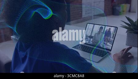 Using VR headset woman wearing blue hoodie working on laptop at office desk, copy space Stock Photo