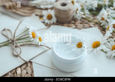 Cream with chamomile extract top view. Stock Photo