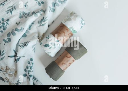 Two baby muslin blankets on white background, top view. Stock Photo
