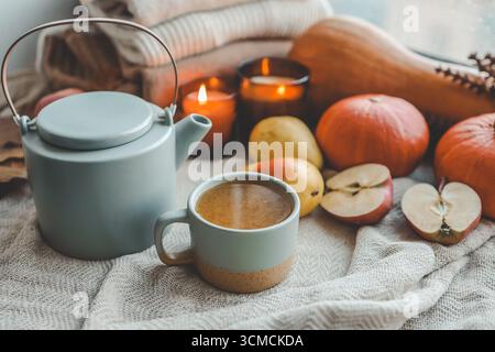 Teapot and cup with sea buckthorn tea, autumn mood. Stock Photo