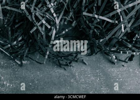 black color shredded paper . Gift box filler background. Stock Photo