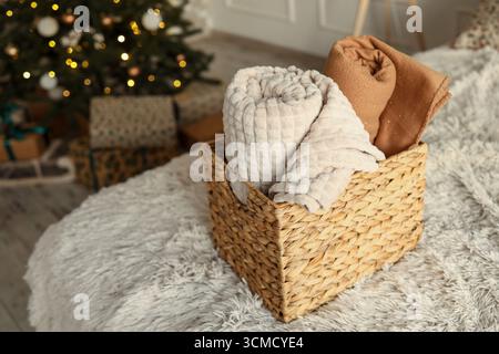 Wicker basket with cozy blankets, home mood. Stock Photo
