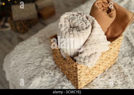 Wicker basket with cozy blankets, home mood. Stock Photo