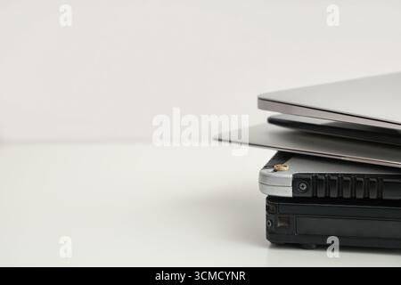 Stack of different modern gadgets on light background Stock Photo