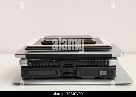 Stack of different modern gadgets on light background Stock Photo
