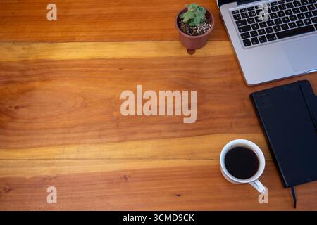Minimalist flat lay with book, coffee cup, and spectacles on rustic wood background Stock Photo