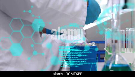 Handling technician's gloved hands pipetting samples into rack at lab bench with digital overlay Stock Photo