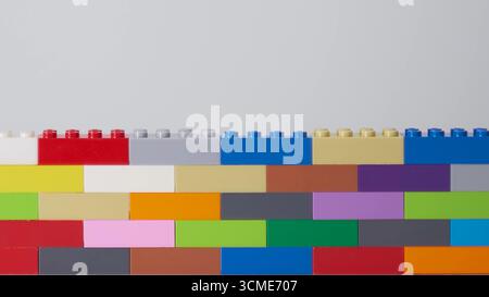 plastic building block. plastic brick wall. Wall from Plastic building blocks isolated. Suitable for greetings card, holidays. White background. stock Stock Photo