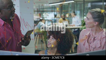 Three colleagues collaborating on data overlays in open-plan office, with tablet and laptops Stock Photo