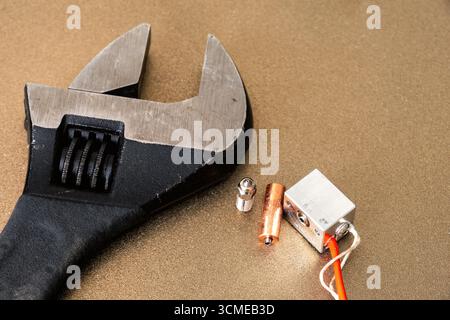 Black wrench to fix broken 3d printer hot end and nozzle. Equipment repair and maintenance. Engineering and technology Stock Photo